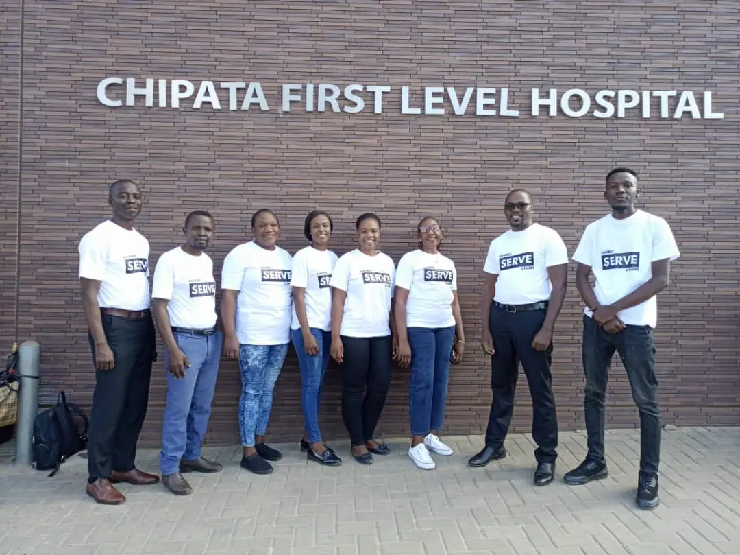 Pastor Alfred Phiri and others standing outside Chipata Level One Hospital